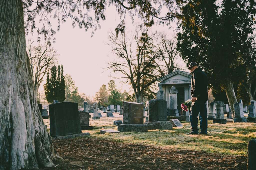 Photo by Brett Sayles: https://www.pexels.com/photo/man-in-black-jacket-standing-in-front-of-grave-3648309/